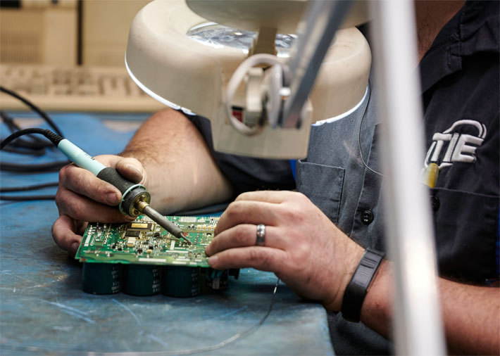 Man repairing robot part